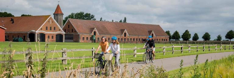 Cyclists cycling past Engestofte Estate in summer